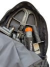 Interior of Nokta DetectoBag showing a search coil, pinpointer, and digging tool in organized compartments.