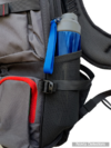 Nokta DetectoBag backpack side mesh pocket holding a blue water bottle with adjustable compression strap and red zipper.
