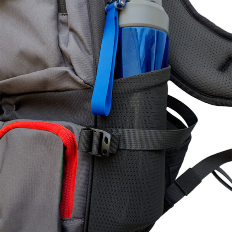 Nokta DetectoBag Side Mesh Pocket and Water Bottle Holder Nokta DetectoBag backpack side mesh pocket holding a blue water bottle with adjustable compression strap and red zipper.