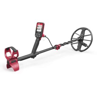 A side-angle view of the Nokta FINDX Pro metal detector in red and black, showing the digital interface, armrest, and circular search coil on a white background.